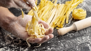 close-up-chef-making-pasta-near-rolling-pin